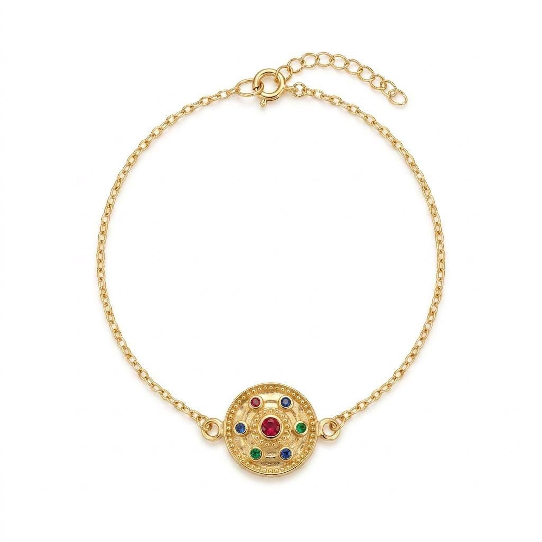 A gold-colored bracelet with a circular pendant featuring a medley of gemstones.