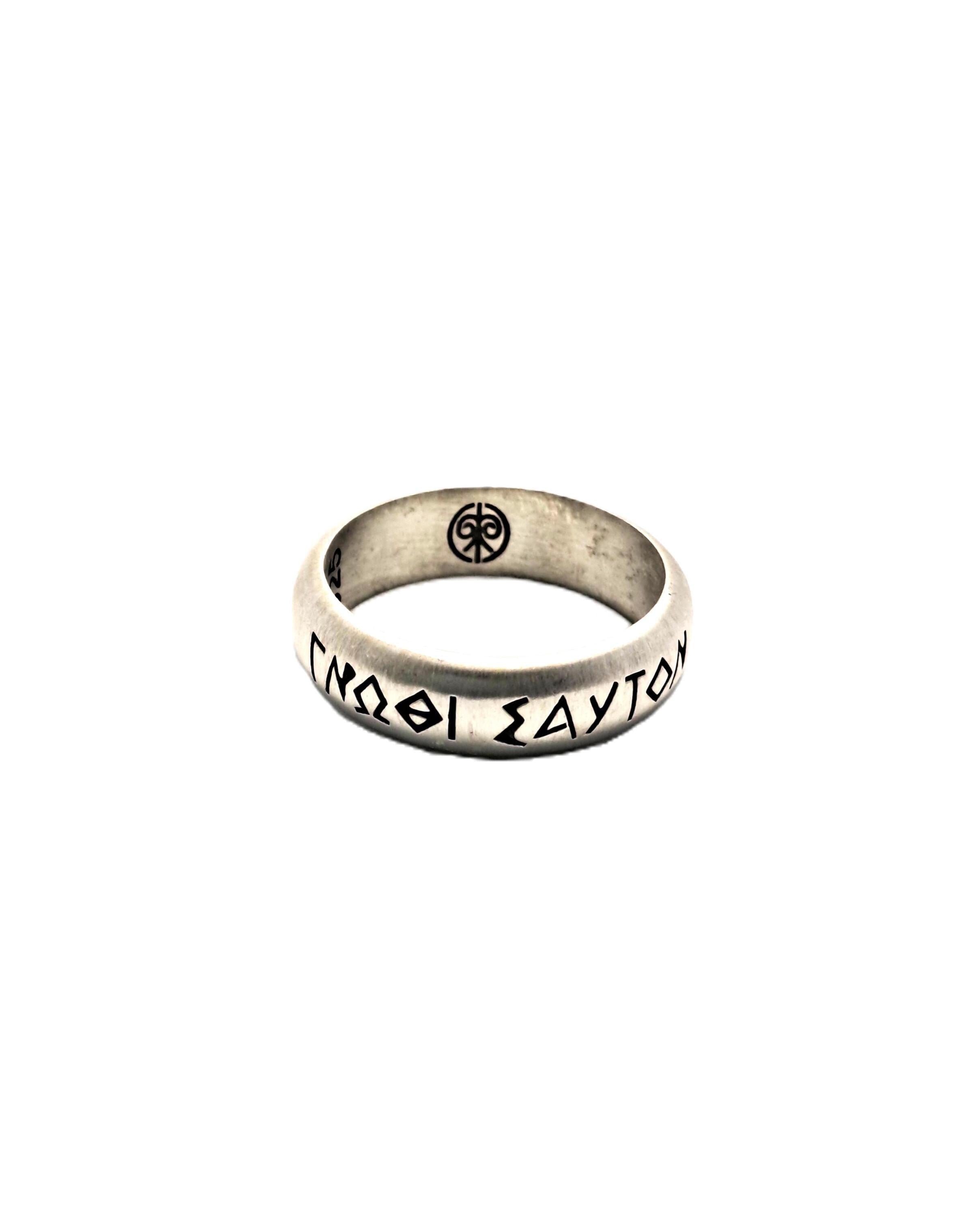 A silver ring with the inscription "ΔΕΛΑΙΚΑΙ" (Greek) on it.