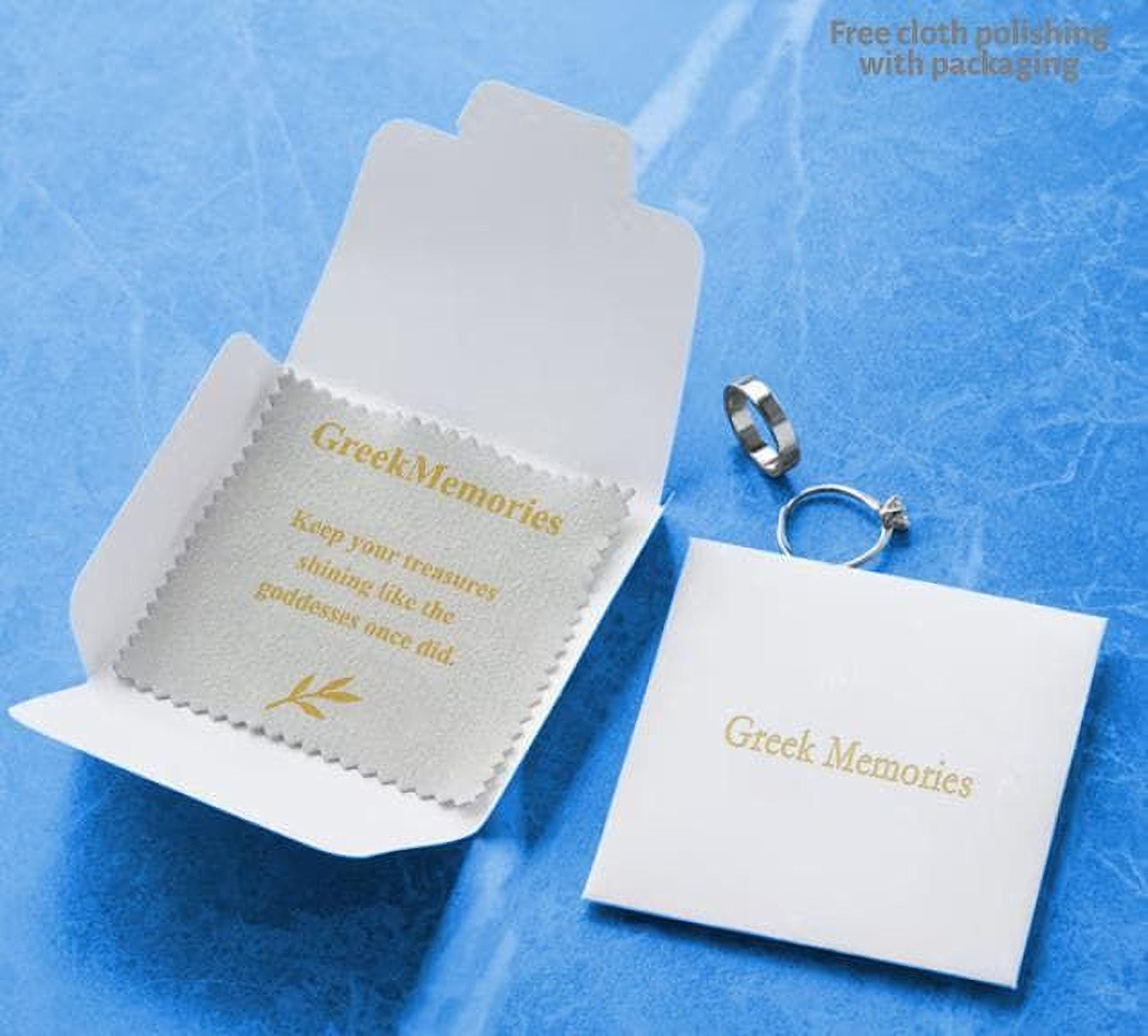 a white box with a label and a silver ring placed on a blue background.
