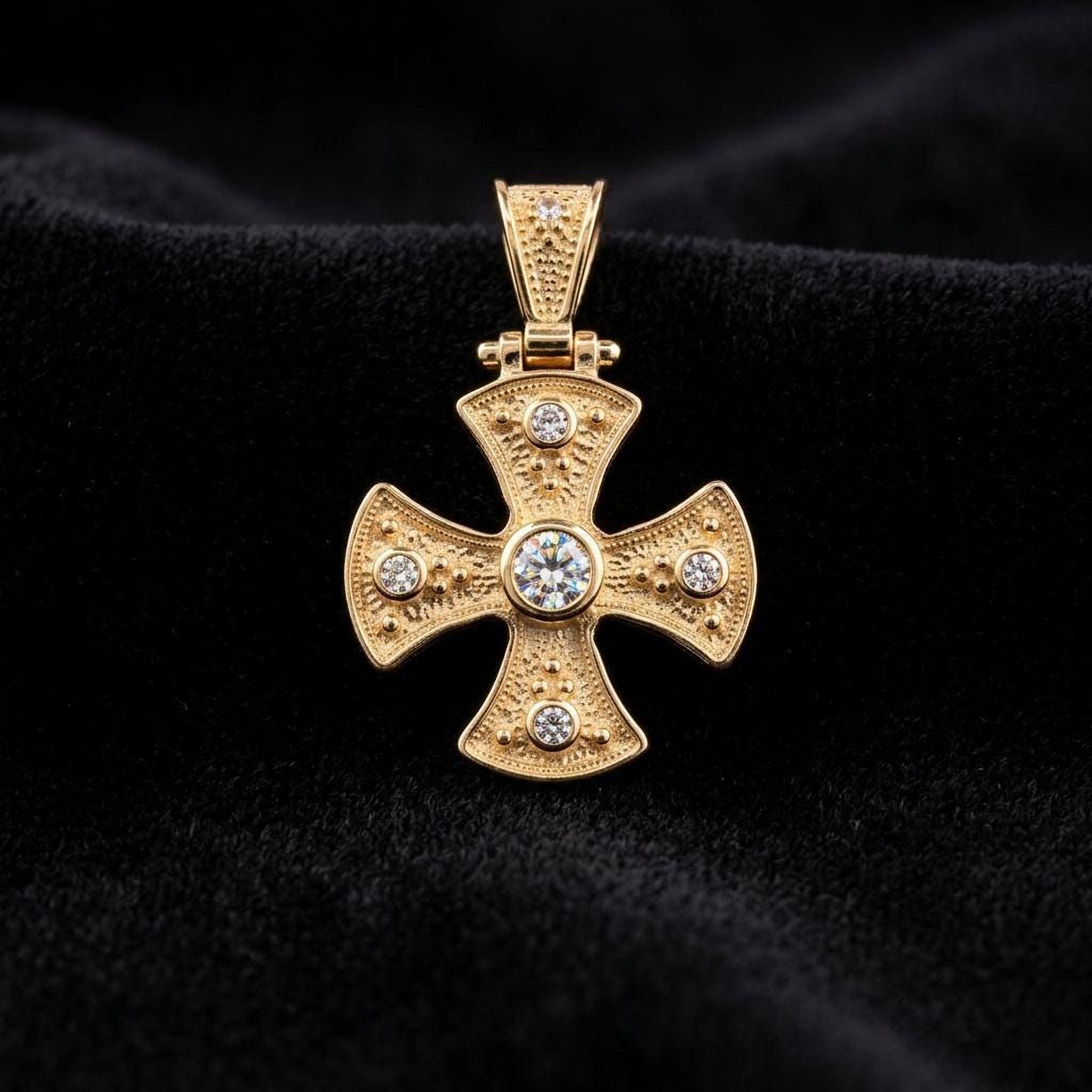 A gold cross pendant with diamonds set in the center, displayed against a dark background.