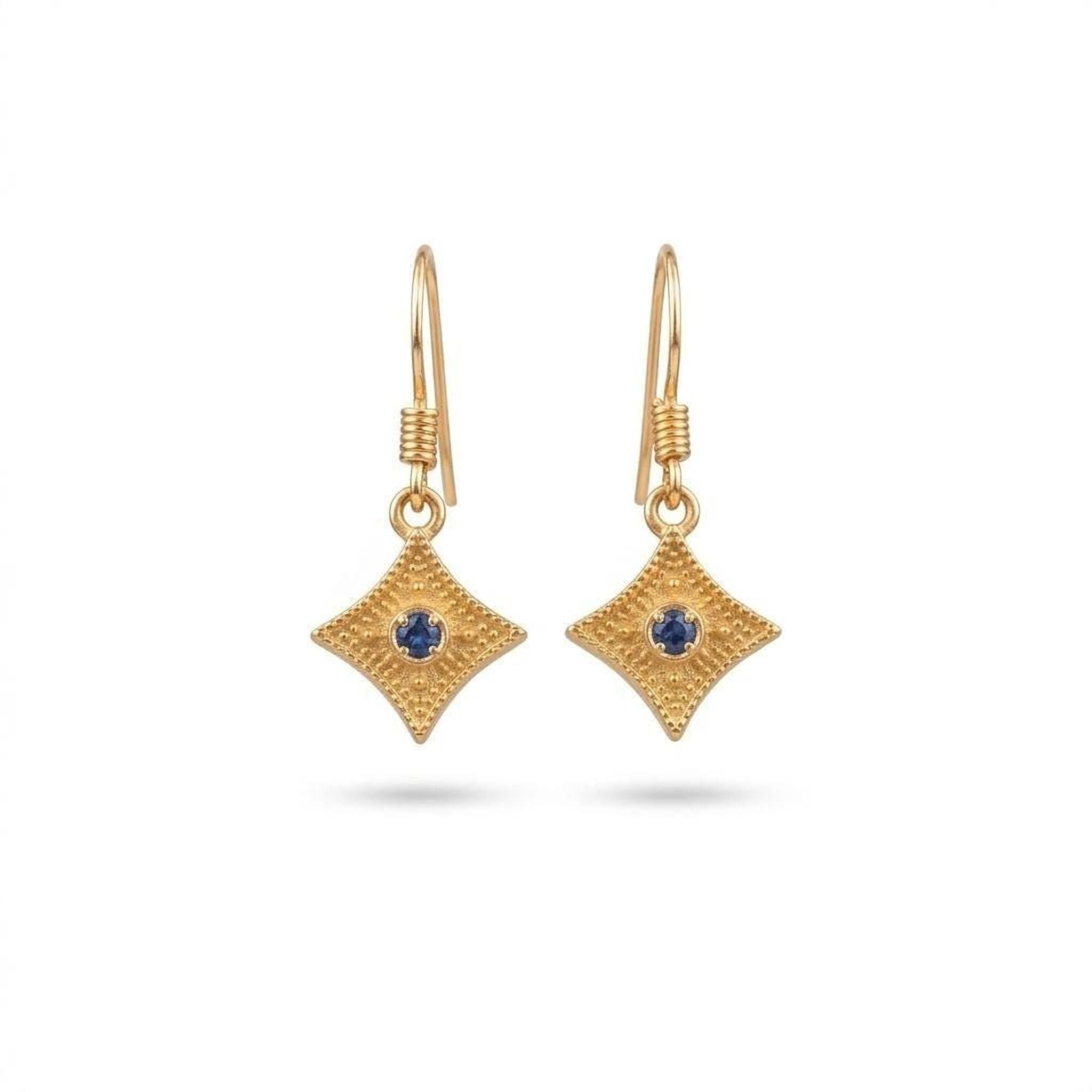 A pair of gold earrings with a blue gemstone in the center.