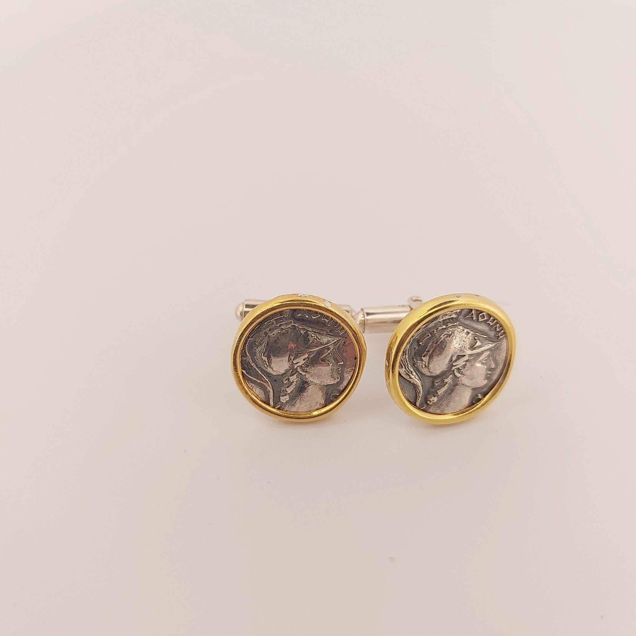 two round cufflinks with a silver and gold design, depicting a woman's profile.