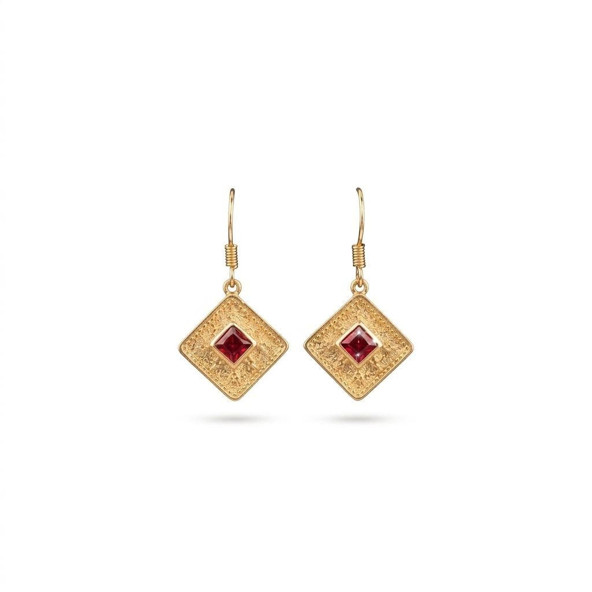 A pair of gold earrings with a diamond-shaped design and a red gemstone in the center.